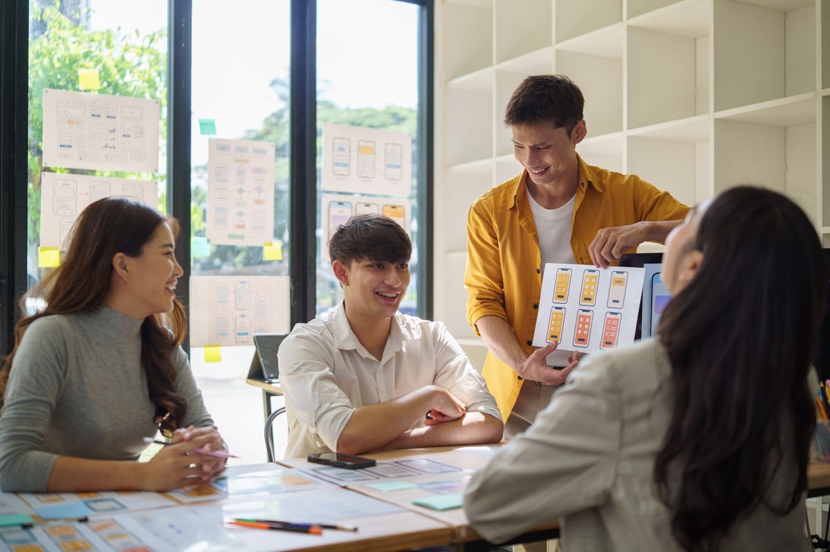 Designer presenting wireframes in creative workspace